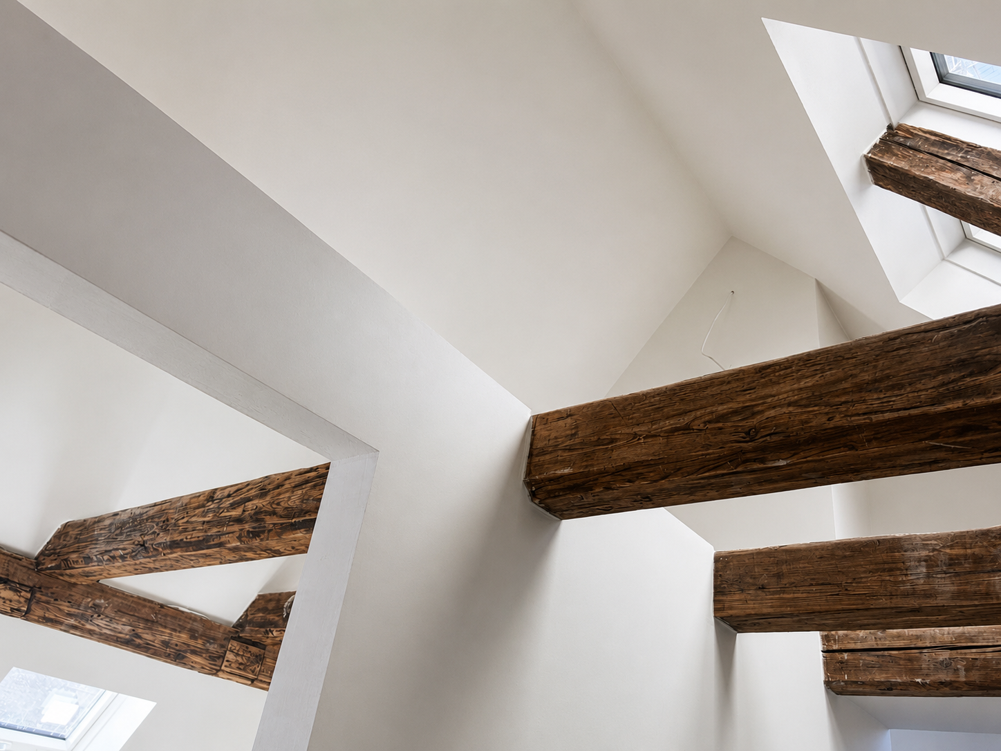 Restored roof timbers beneath a roof window